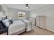 Comfortable bedroom with a ceiling fan, light wood floor, and two wooden dressers at 511 Foxglove Cir # B, Sun City Center, FL 33573