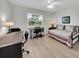 Comfortable bedroom featuring a desk area and a cozy bed with natural light from the window at 511 Foxglove Cir # B, Sun City Center, FL 33573