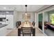 Dining room adjacent to kitchen featuring a wood table set for four and sliding glass doors to outdoor seating at 511 Foxglove Cir # B, Sun City Center, FL 33573