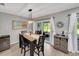 Cozy dining area with a modern chandelier and sliding doors that lead to the outdoor space at 511 Foxglove Cir # B, Sun City Center, FL 33573