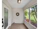 Inviting enclosed entryway featuring a modern door, a decorative wreath, and plenty of natural light at 511 Foxglove Cir # B, Sun City Center, FL 33573