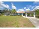 Charming single Gathering home with a well-maintained lawn, palm tree, and light blue exterior with two carports at 511 Foxglove Cir # B, Sun City Center, FL 33573