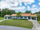 Charming single-Gathering home with manicured lawn, blue shutters, and convenient covered parking at 511 Foxglove Cir # B, Sun City Center, FL 33573
