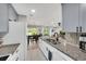 Bright kitchen boasts granite counters, stainless sink and faucet, and flows into the dining and living areas at 511 Foxglove Cir # B, Sun City Center, FL 33573