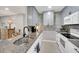 Modern kitchen featuring granite countertops, stainless appliances, gray cabinets, and decorative backsplash at 511 Foxglove Cir # B, Sun City Center, FL 33573