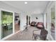 Enclosed lanai with seating, windows, and sliding doors to both outside and inside the home at 511 Foxglove Cir # B, Sun City Center, FL 33573