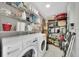 Functional laundry room with appliances, shelving, and storage space for supplies at 511 Foxglove Cir # B, Sun City Center, FL 33573