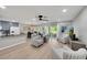 Open-concept living room with modern furnishings, sleek floors, and sliding glass doors to the outdoor patio at 511 Foxglove Cir # B, Sun City Center, FL 33573