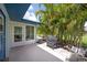 Open-air patio with room for a grill and furniture surrounded by lush tropical foliage at 511 Foxglove Cir # B, Sun City Center, FL 33573