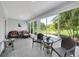 Relaxing sunroom featuring seating, large windows with lush outdoor views, and a tiled floor at 511 Foxglove Cir # B, Sun City Center, FL 33573