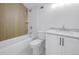 Well-lit bathroom includes a shower/bathtub combo, white subway tile, and marble countertop at 5124 3Rd N Ave, St Petersburg, FL 33710