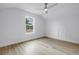 Bright bedroom features wood-look floors, window, and sloped ceilings at 5124 3Rd N Ave, St Petersburg, FL 33710