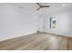 Bright bedroom features wood-look floors, a modern ceiling fan, and a sunlit window at 5124 3Rd N Ave, St Petersburg, FL 33710