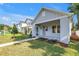 Attractive home featuring a well-maintained lawn and inviting walkway to the covered porch at 5124 3Rd N Ave, St Petersburg, FL 33710