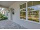 Side view of a home's inviting front porch featuring stone pavers and stylish lighting at 5124 3Rd N Ave, St Petersburg, FL 33710