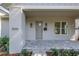 Close-up of a home's inviting front porch with stone pavers, stylish lighting, and manicured landscaping at 5124 3Rd N Ave, St Petersburg, FL 33710