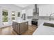 Kitchen features stainless appliances, an eat-in island, stone countertops, and backyard access at 5124 3Rd N Ave, St Petersburg, FL 33710