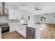 Open kitchen boasts an eat-in island, stainless appliances, stone countertops, and ample cabinet space at 5124 3Rd N Ave, St Petersburg, FL 33710