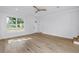 Bright living room with hardwood floors, a large window, and a white front door at 5124 3Rd N Ave, St Petersburg, FL 33710
