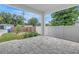 View of a covered patio with concrete pavers, a white fence, and landscaping at 5124 3Rd N Ave, St Petersburg, FL 33710