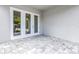 Covered patio boasts neutral paint, concrete pavers, and glass doors to the interior at 5124 3Rd N Ave, St Petersburg, FL 33710