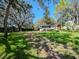 Spacious backyard with shade trees, RV and small storage trailer at 6207 Ridge Top Dr, New Port Richey, FL 34655