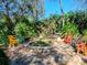 Backyard fire pit with flagstone base surrounded by colorful adirondack chairs at 6207 Ridge Top Dr, New Port Richey, FL 34655