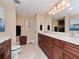 Spacious bathroom with a double vanity, tile floors, and a separate toilet area at 6207 Ridge Top Dr, New Port Richey, FL 34655