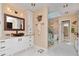 Elegant bathroom with dual vanities, a soaking tub, and a walk-in shower at 6207 Ridge Top Dr, New Port Richey, FL 34655