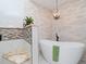 Beautiful bathroom featuring a freestanding tub, chandelier and tiled walls at 6207 Ridge Top Dr, New Port Richey, FL 34655