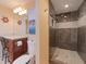 Coastal-themed bathroom with a glass-enclosed shower and vanity with stylish nautical decor at 6207 Ridge Top Dr, New Port Richey, FL 34655