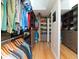 Well-organized walk-in closet with custom shelving, hanging rods, and hardwood floors at 6207 Ridge Top Dr, New Port Richey, FL 34655