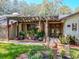 Charming front entrance with a pergola, beautiful plants, and decorative elements creating a warm and inviting ambiance at 6207 Ridge Top Dr, New Port Richey, FL 34655
