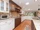 Expansive kitchen with white and wood cabinets, granite counters, and stainless steel appliances at 6207 Ridge Top Dr, New Port Richey, FL 34655