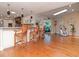 Open-concept living space with hardwood floors, a bar, and seamless flow for entertaining at 6207 Ridge Top Dr, New Port Richey, FL 34655