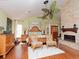 Spacious bedroom with hardwood floors, a brick fireplace, and a leaf-themed ceiling fan at 6207 Ridge Top Dr, New Port Richey, FL 34655