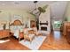 Comfortable bedroom with hardwood floors, a brick fireplace, and a vaulted ceiling at 6207 Ridge Top Dr, New Port Richey, FL 34655