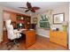 Well-appointed home office with hardwood floors, built-in shelving, and a comfortable workspace at 6207 Ridge Top Dr, New Port Richey, FL 34655