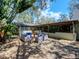 Cozy backyard patio featuring ample seating around a fountain and a covered porch at 6207 Ridge Top Dr, New Port Richey, FL 34655