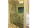 Modern shower with a built-in bench and decorative tile, surrounded by clear glass enclosure at 6207 Ridge Top Dr, New Port Richey, FL 34655