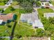 An aerial view shows the layout of the home, including a detached garage, backyard and covered porch area at 6219 Hampton N Dr, St Petersburg, FL 33710