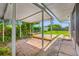 View of covered patio area leading to a backyard with partial grass, landscaping, and an area for relaxing at 6219 Hampton N Dr, St Petersburg, FL 33710