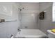 Bathroom showcasing full tub with gray tiling and an adjustable shower head at 6219 Hampton N Dr, St Petersburg, FL 33710