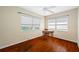 Bright bedroom with hardwood floors, ceiling fan, and windows with modern blinds, ready for a new owner at 6219 Hampton N Dr, St Petersburg, FL 33710