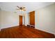 Bedroom showcasing hardwood floors, ceiling fan, window and closet with drawers at 6219 Hampton N Dr, St Petersburg, FL 33710