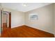 Neutral bedroom features wood floors, one window with blinds, and white walls at 6219 Hampton N Dr, St Petersburg, FL 33710