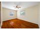 Bright bedroom with two windows and ceiling fan, showcasing wood floors at 6219 Hampton N Dr, St Petersburg, FL 33710