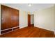 Bedroom features beautiful hardwood floors, a closet and attached drawers at 6219 Hampton N Dr, St Petersburg, FL 33710