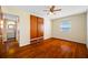 Bedroom with window, wood floors and closet, leading to attached bathroom at 6219 Hampton N Dr, St Petersburg, FL 33710
