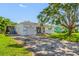 Well-maintained home with an attached garage, front porch, and driveway with mature landscaping at 6219 Hampton N Dr, St Petersburg, FL 33710